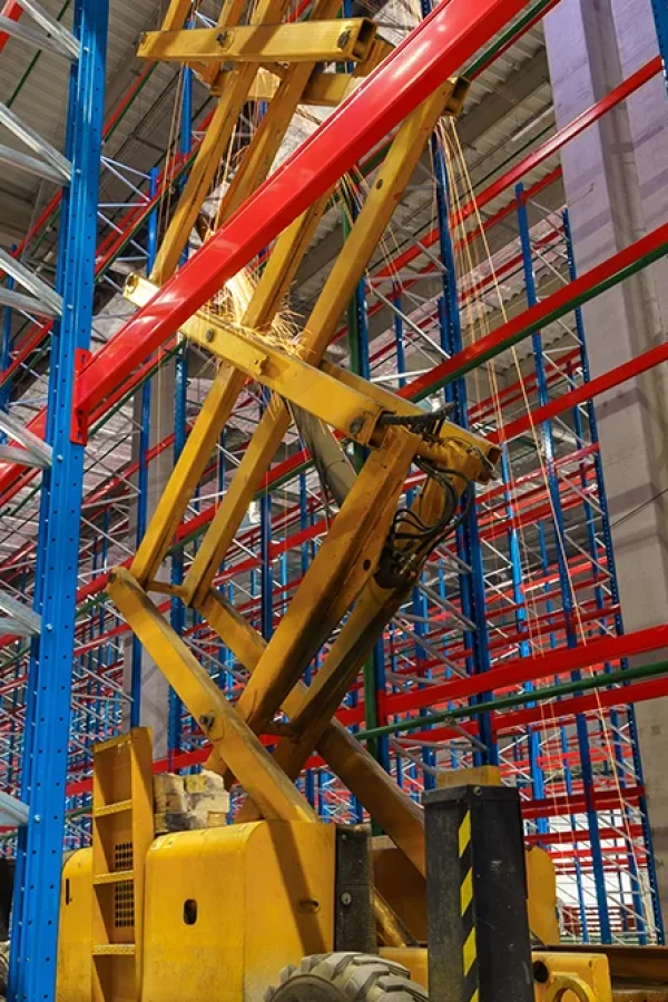 Montaje de sistemas de almacenaje industrial con estructuras metálicas y maquinaria de elevación en un centro logístico moderno – MODEX 360.